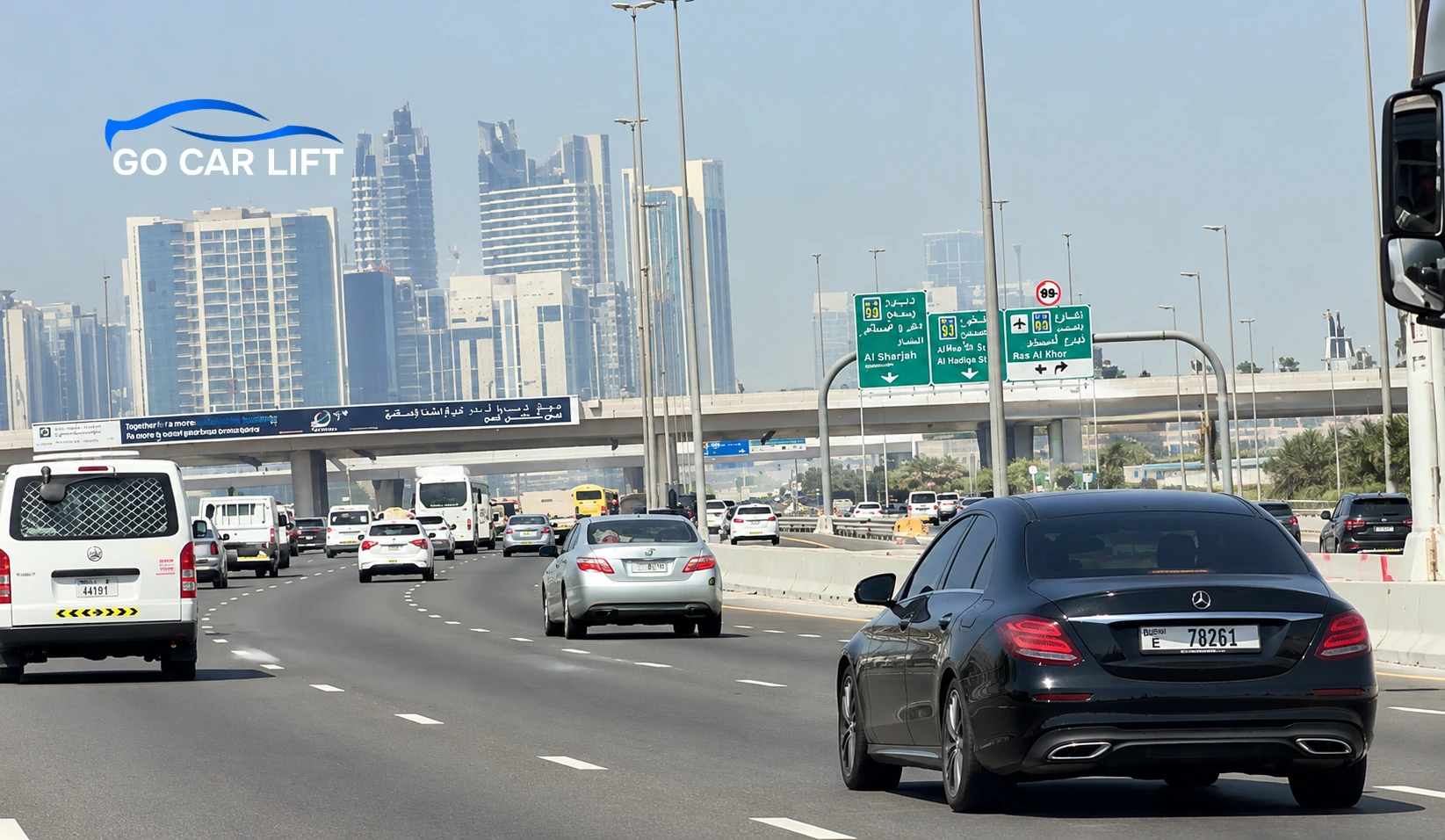 Go Car Lift logo over busy UAE highway traffic for Car Lift Dubai to Abu Dhabi.