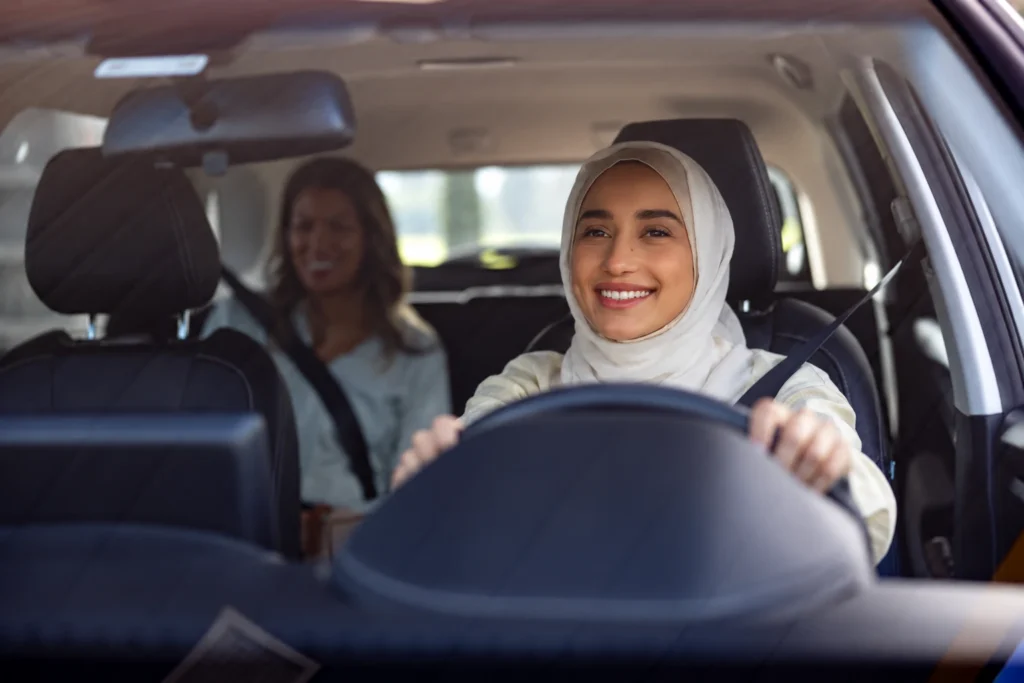Female driver driving a passenger using a ladies car lift Abu Dhabi to Dubai service.